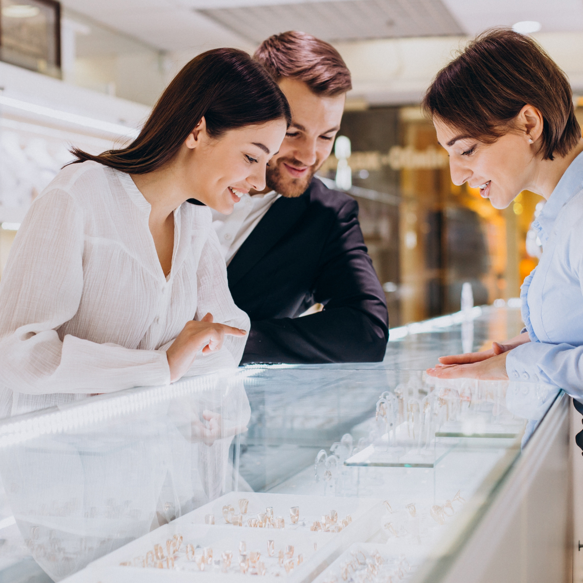 individuals shopping for jewelry in store