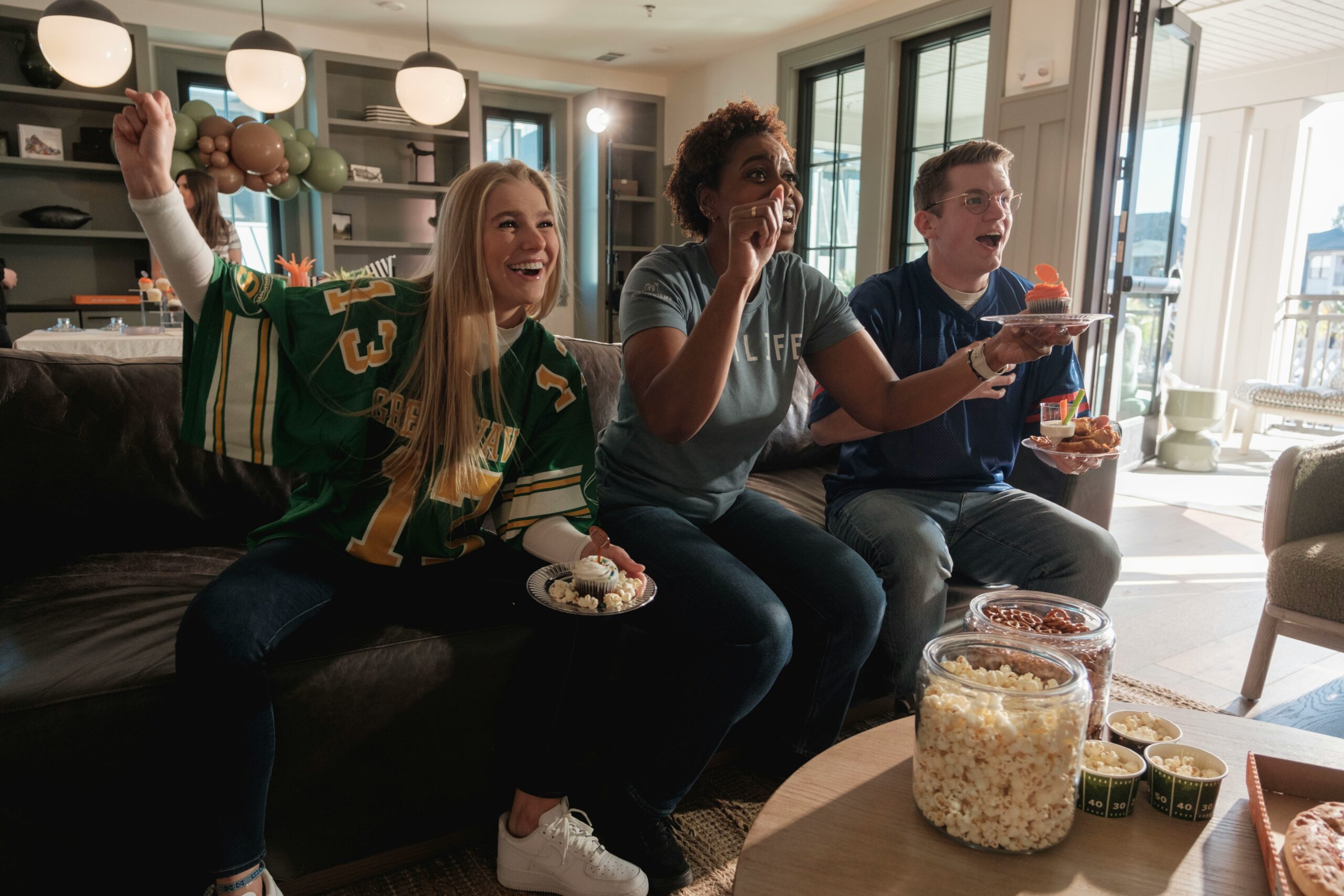 friends watching sporting event on tv