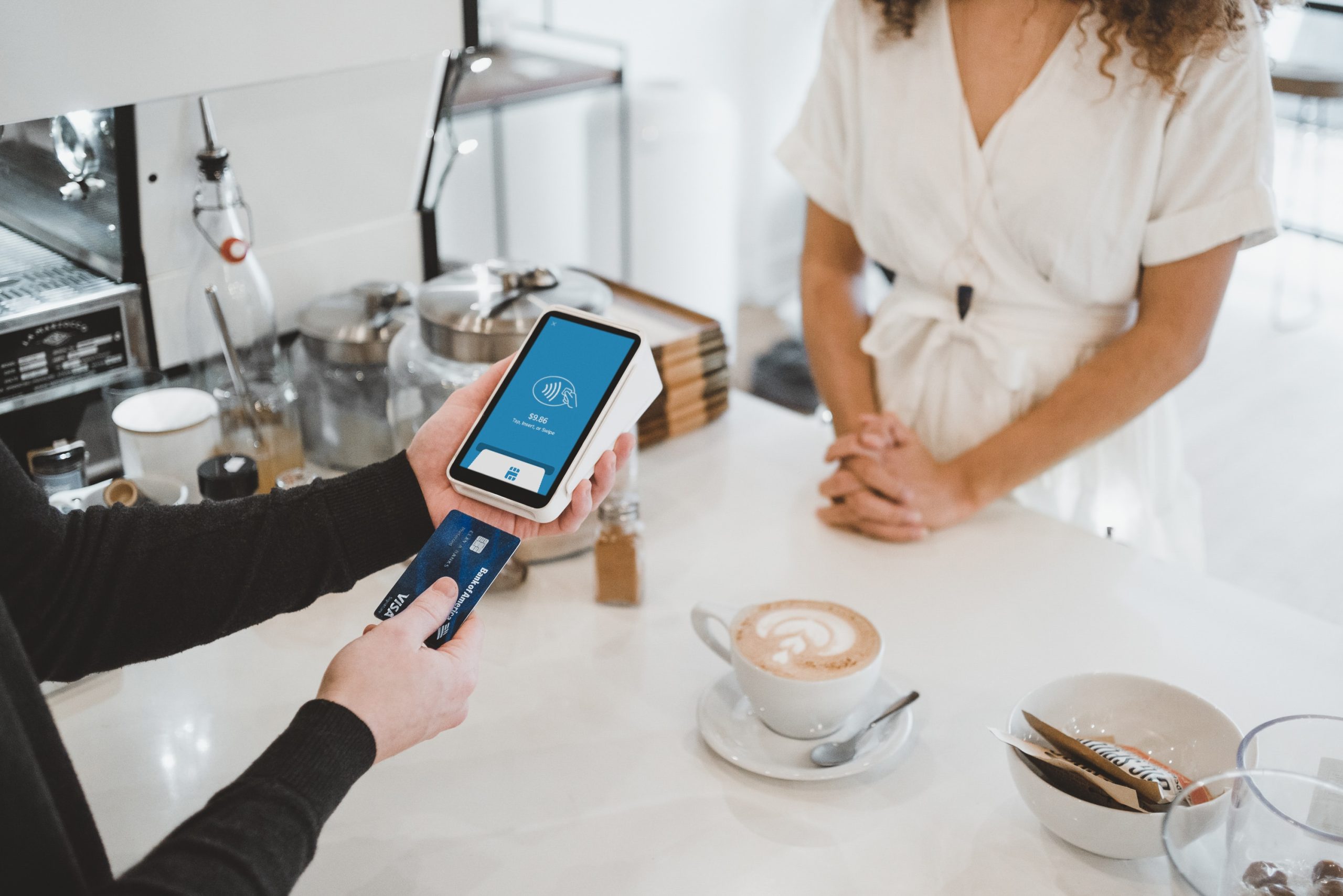 consumer checking out of coffee store and paying for their order