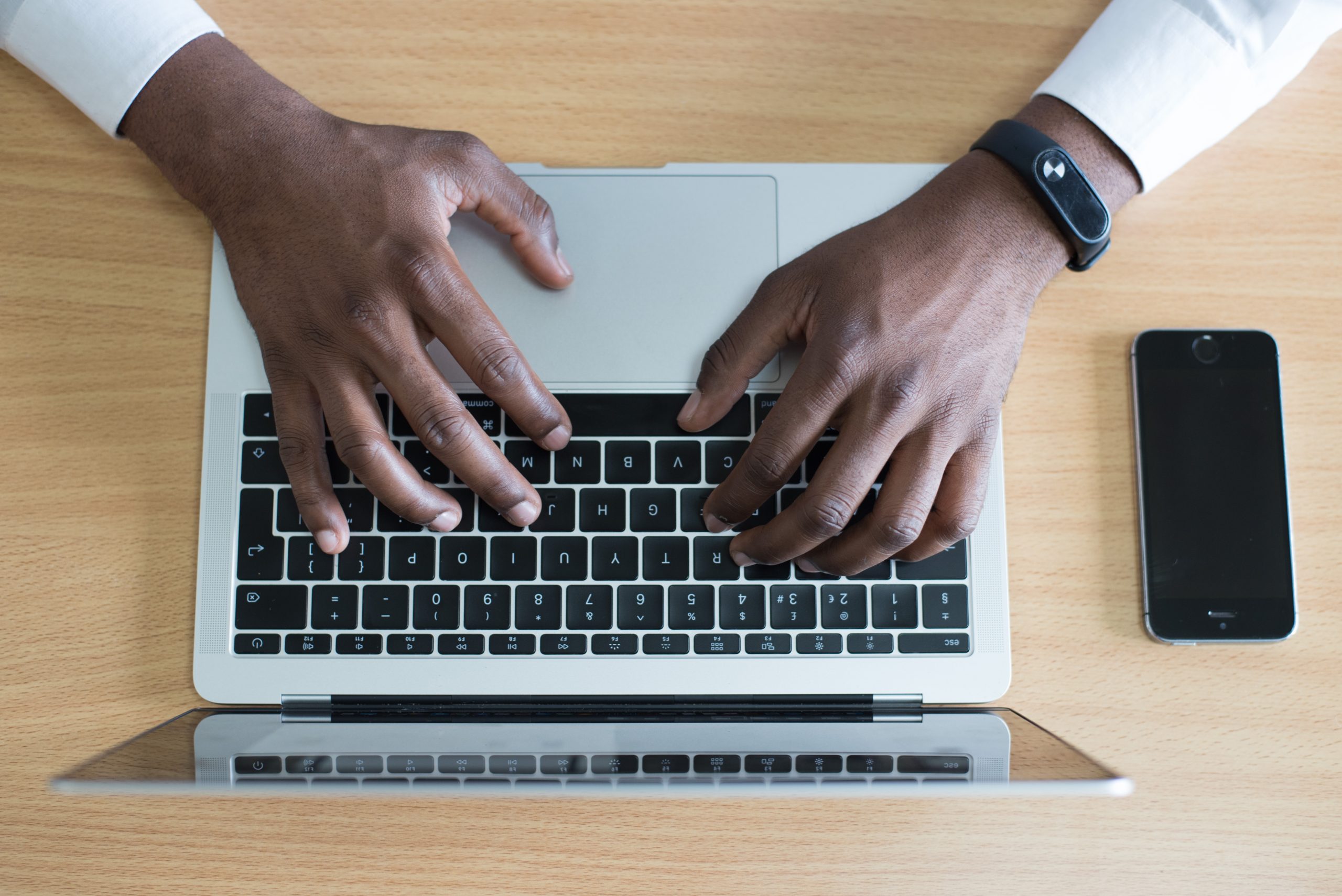 Arial view man typing on laptop