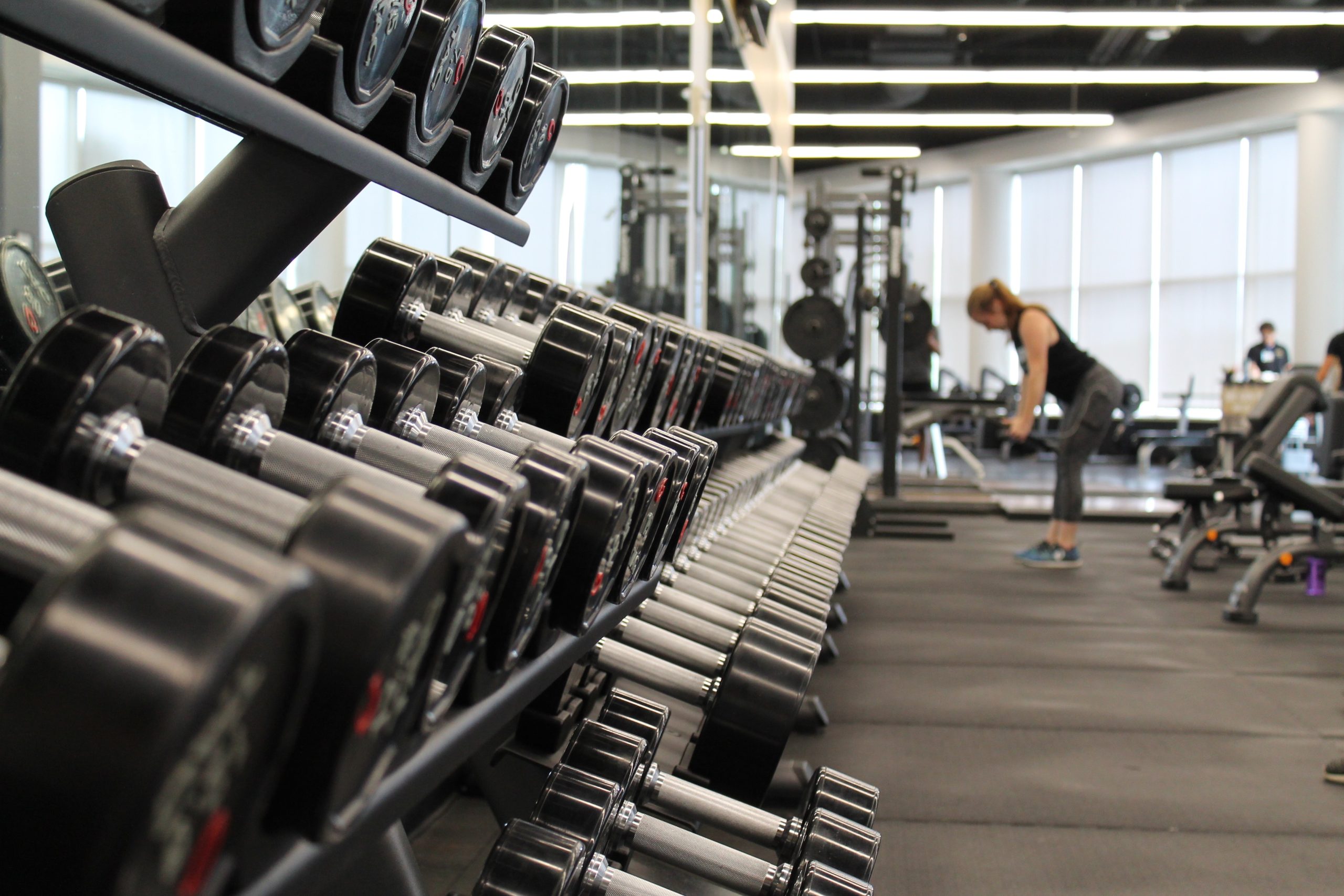 individual working out at a gym with free weights