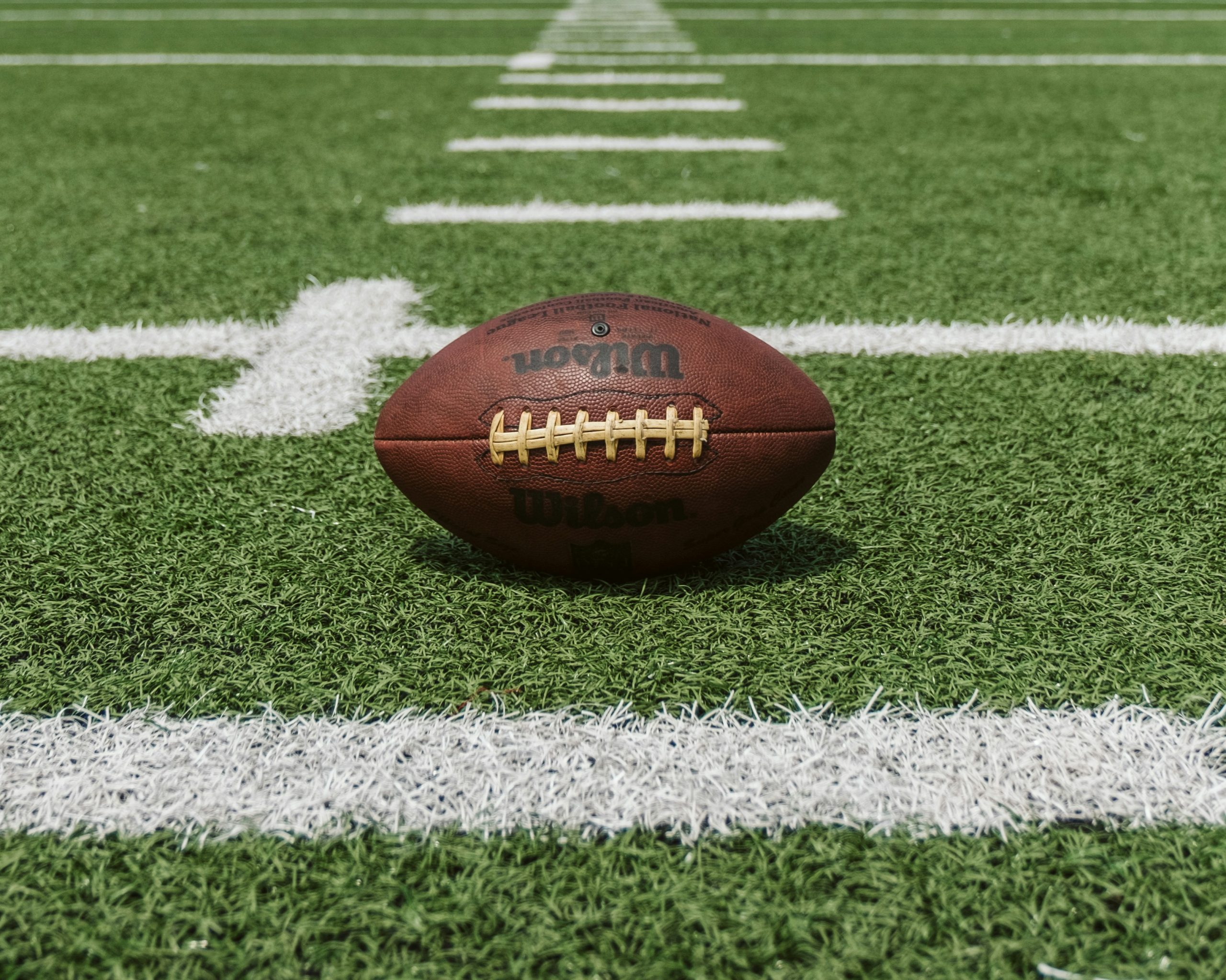 football sitting on a football field, NFL marketing