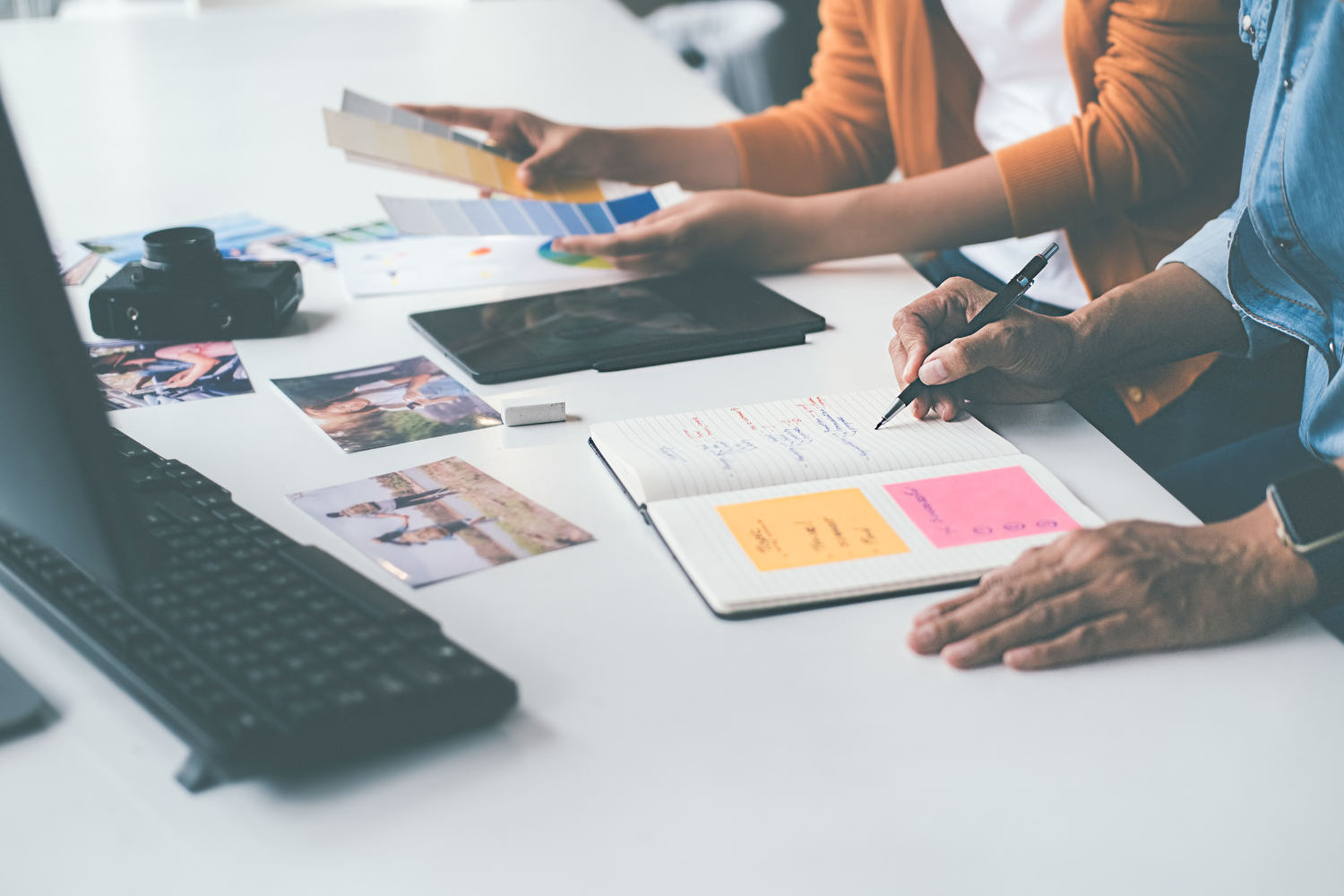 image of desk with people working on projects