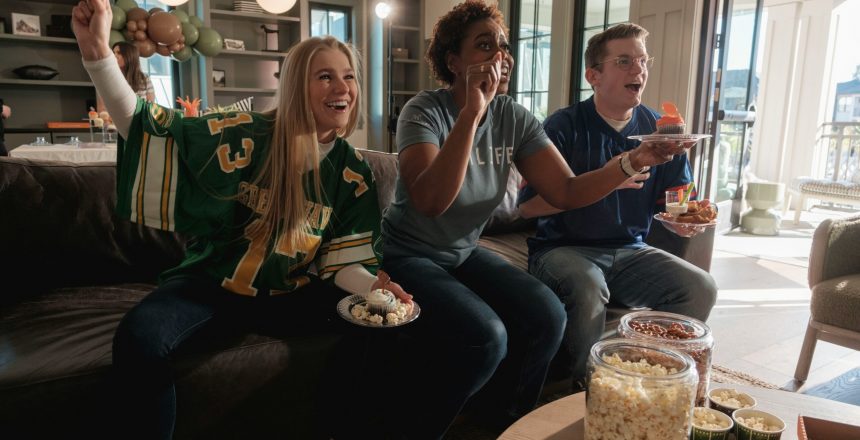 friends watching sporting event on tv