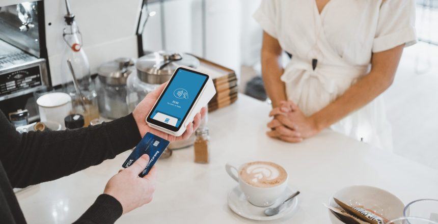 consumer checking out of coffee store and paying for their order