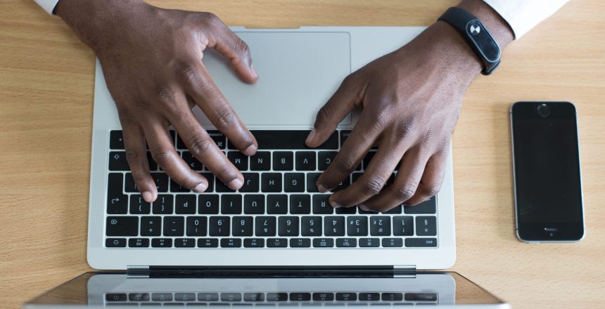 Arial view man typing on laptop