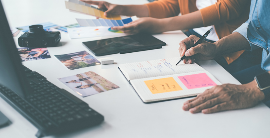 image of desk with people working on projects