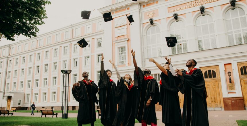 graduates toss caps
