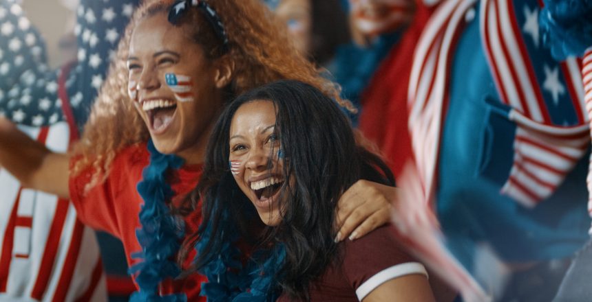 Excited,Fans,With,Us,Flag,In,Sports,Crowd,Celebrating,On
