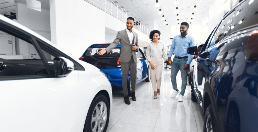 couple shopping for a car, car shoppers inside an auto dealership