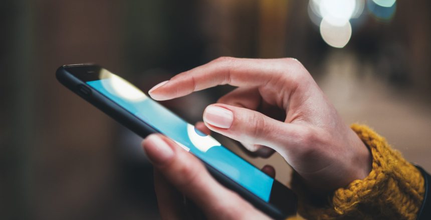 point finger on screen mobile phone closeup, person texting text message, hipster touch blue screen on smartphone light night city, girls using in hands cellphone close up, online internet