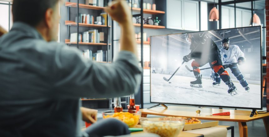 At,Home,Ice,Hockey,Fans,Sitting,On,A,Couch,Watch