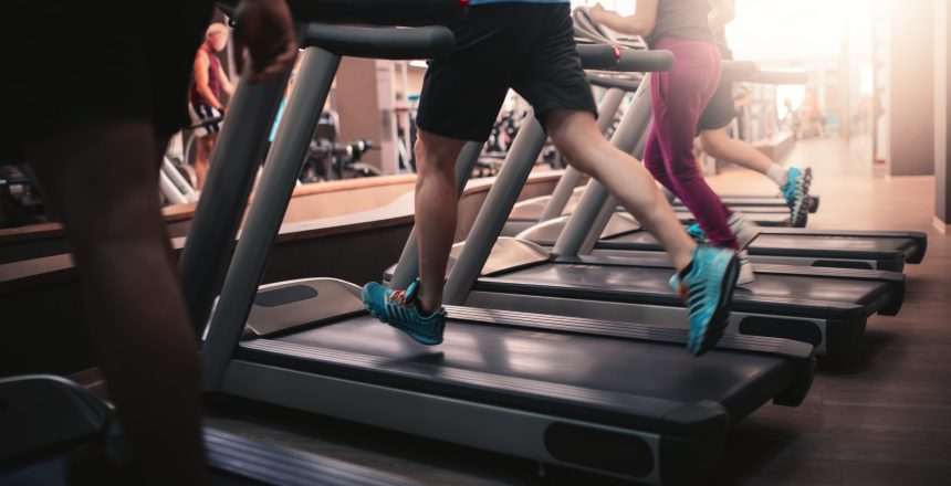 busy gym, people running on treadmill