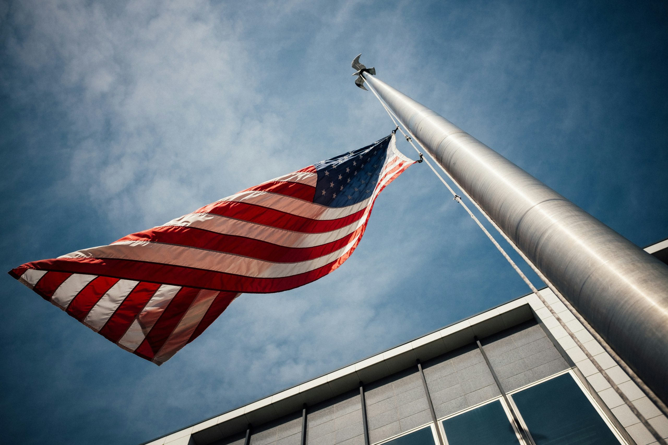 worm's eye view of the american flag flying